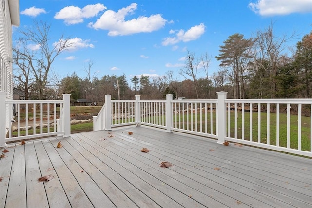 wooden terrace with a lawn