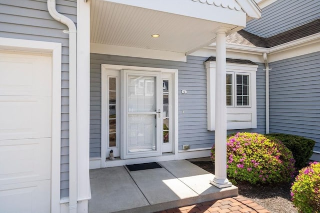 property entrance with an attached garage and a porch