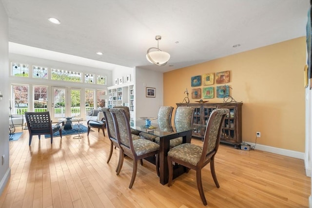 dining space featuring recessed lighting, baseboards, and light wood finished floors