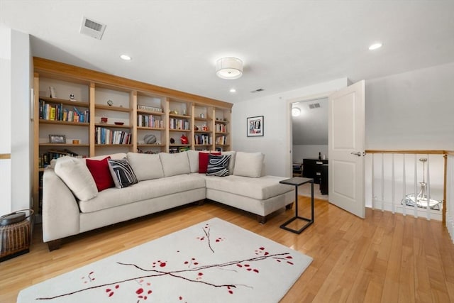 living area with recessed lighting, visible vents, and light wood finished floors