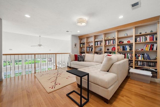 living area featuring visible vents, light wood-style flooring, and ceiling fan