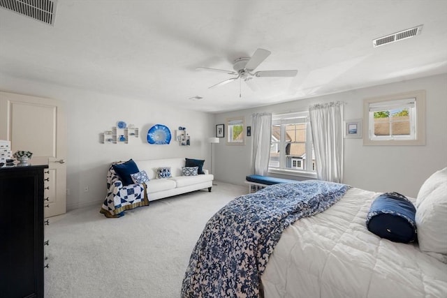 carpeted bedroom featuring ceiling fan and visible vents