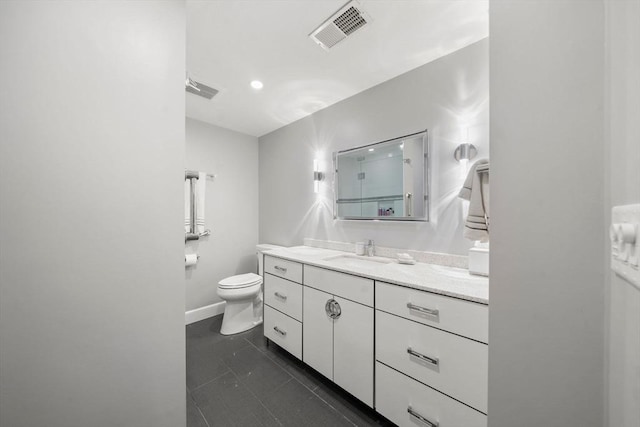 bathroom featuring vanity, tile patterned floors, toilet, and visible vents