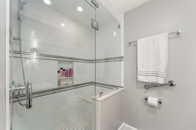 bathroom with baseboards, tile patterned flooring, a shower stall, and recessed lighting