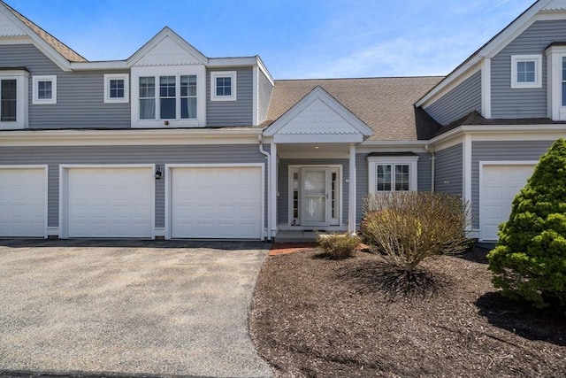 multi unit property with a shingled roof and aphalt driveway