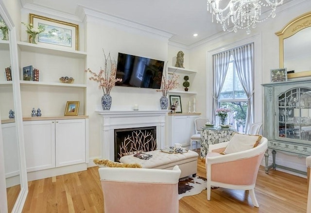 376 Marlborough St Unit 4, Boston, MA 02116 - living area with crown molding, light wood finished floors, a chandelier, a fireplace, and built in features