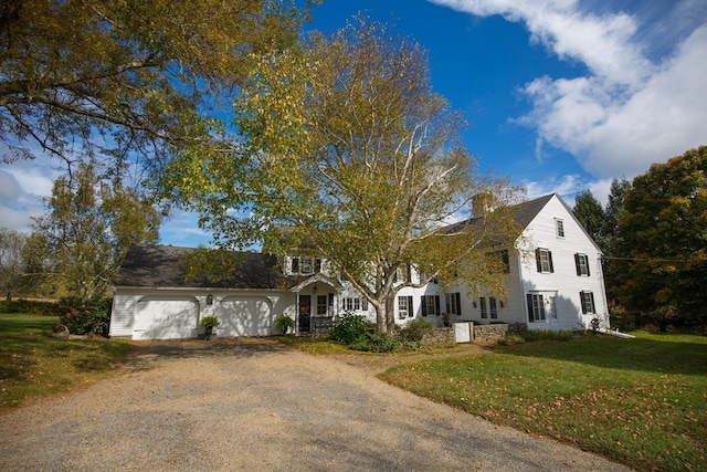 view of front of house with a front yard and a garage