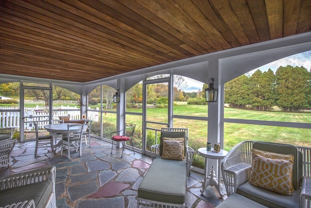 sunroom / solarium featuring wooden ceiling and plenty of natural light