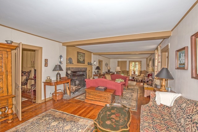 living room featuring wood-type flooring, beamed ceiling, and crown molding