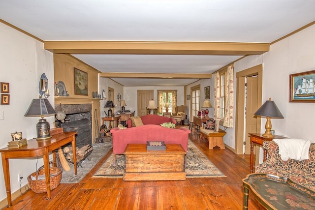 living room with ornamental molding, wood-type flooring, beam ceiling, and french doors