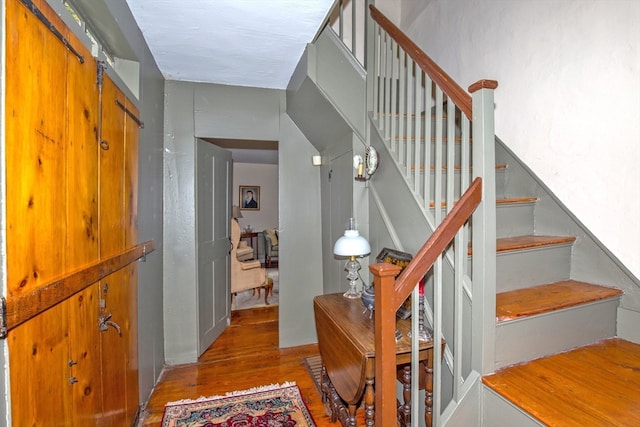 stairway with hardwood / wood-style flooring