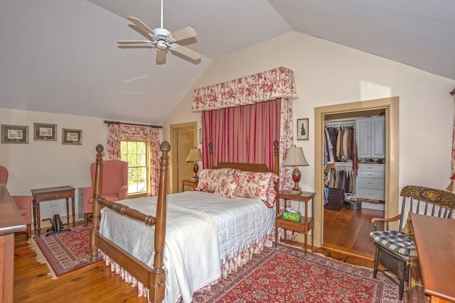 bedroom featuring lofted ceiling, hardwood / wood-style floors, ceiling fan, and a closet