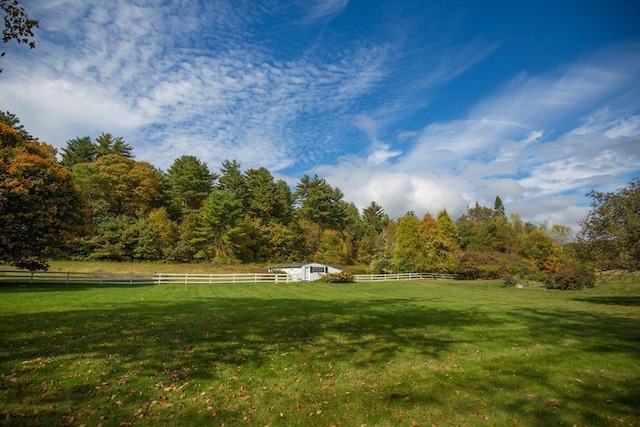 surrounding community featuring a lawn and a rural view