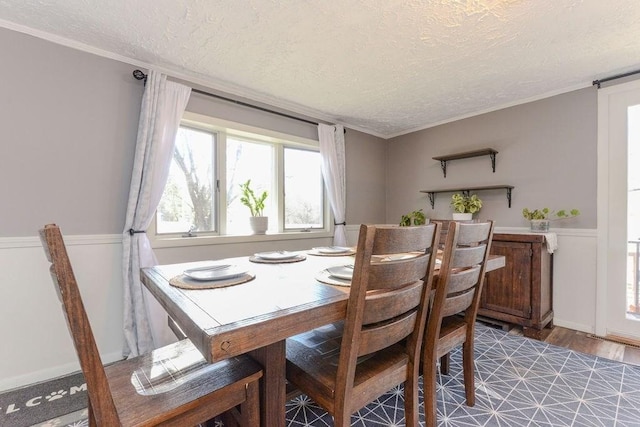 dining space featuring hardwood / wood-style flooring and a textured ceiling