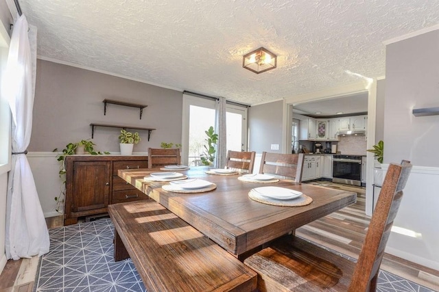 dining space with crown molding and a textured ceiling