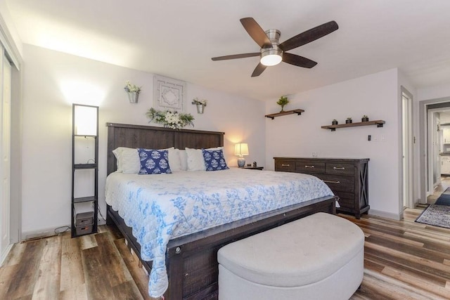 bedroom with ceiling fan and hardwood / wood-style flooring