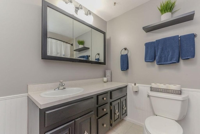 bathroom with tile patterned floors, vanity, and toilet