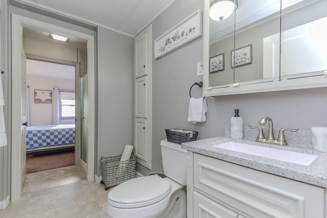 bathroom with vanity, toilet, and crown molding