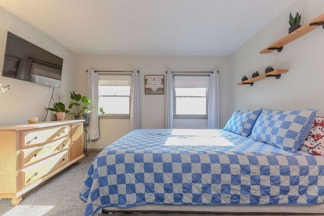 bedroom with carpet flooring and multiple windows