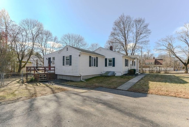 view of property exterior with a deck and a yard