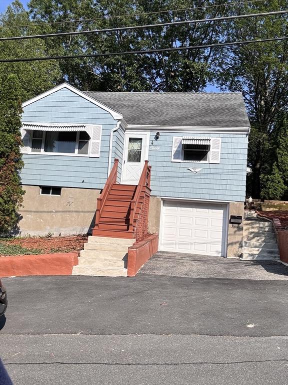 30 Bonavesta, Lynn, MA 01902 - view of front of home with a garage, driveway, and roof with shingles