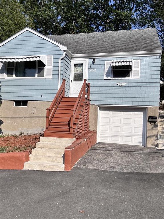 30 Bonavesta, Lynn, MA 01902 - view of front of house with a garage, driveway, and roof with shingles