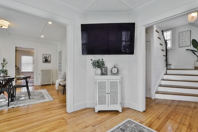 interior space with baseboards, radiator, hardwood / wood-style flooring, stairway, and recessed lighting