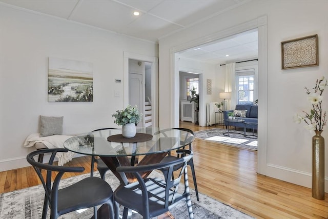 dining room with stairway, light wood-style flooring, and baseboards