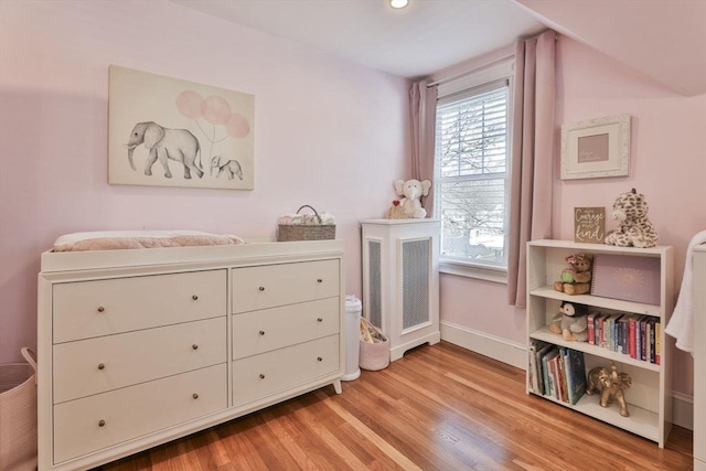 bedroom featuring light wood-style flooring and baseboards