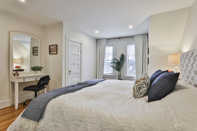 bedroom with recessed lighting, baseboards, and wood finished floors