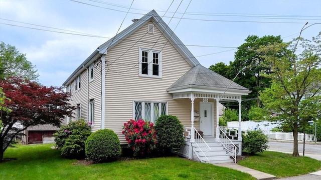 142 Dale St, Waltham, MA 02451 - view of front of home with covered porch and a front lawn