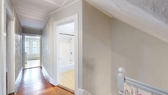 142 Dale St, Waltham, MA 02451 - hall featuring a baseboard radiator, a textured wall, wood finished floors, an upstairs landing, and a textured ceiling