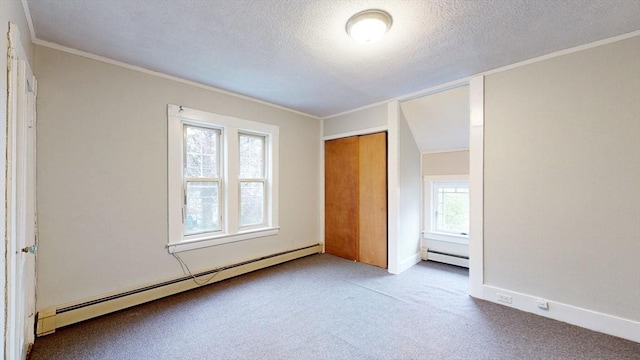 142 Dale St, Waltham, MA 02451 - unfurnished bedroom with a baseboard heating unit, carpet, a textured ceiling, crown molding, and a closet