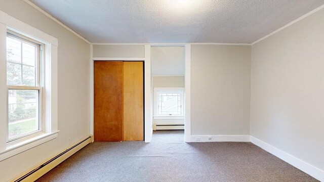 142 Dale St, Waltham, MA 02451 - unfurnished bedroom featuring a baseboard heating unit, carpet, a textured ceiling, multiple windows, and crown molding