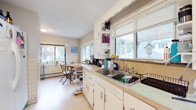 142 Dale St, Waltham, MA 02451 - kitchen with freestanding refrigerator, a sink, open shelves, light countertops, and a wainscoted wall