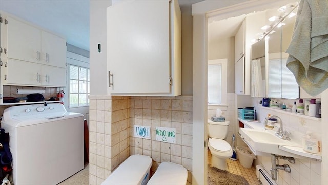 142 Dale St, Waltham, MA 02451 - full bathroom with washer / dryer, toilet, tile walls, tile patterned floors, and a sink