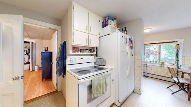 142 Dale St, Waltham, MA 02451 - kitchen with white appliances, baseboard heating, white cabinetry, and light countertops