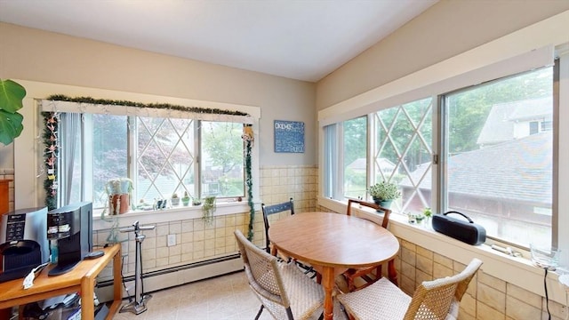 142 Dale St, Waltham, MA 02451 - dining room with a baseboard radiator, light tile patterned flooring, tile walls, and wainscoting