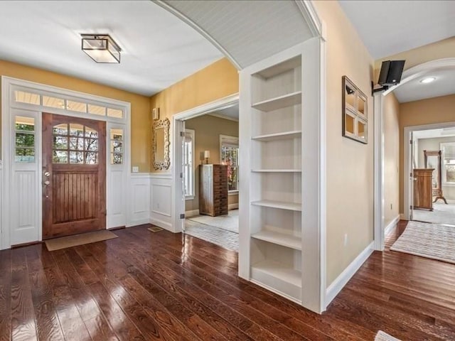 143 Clemence Hill Rd, Southbridge, MA 01550 - entryway featuring hardwood / wood-style flooring, arched walkways, a wainscoted wall, and baseboards