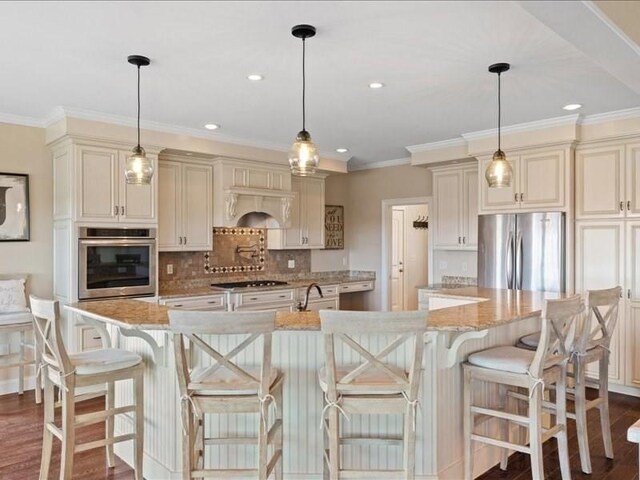 143 Clemence Hill Rd, Southbridge, MA 01550 - kitchen featuring stainless steel appliances, dark wood-style flooring, cream cabinetry, a sink, and ornamental molding