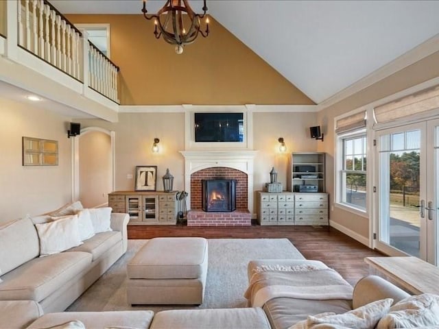 143 Clemence Hill Rd, Southbridge, MA 01550 - living area with high vaulted ceiling, wood finished floors, a fireplace, baseboards, and a chandelier