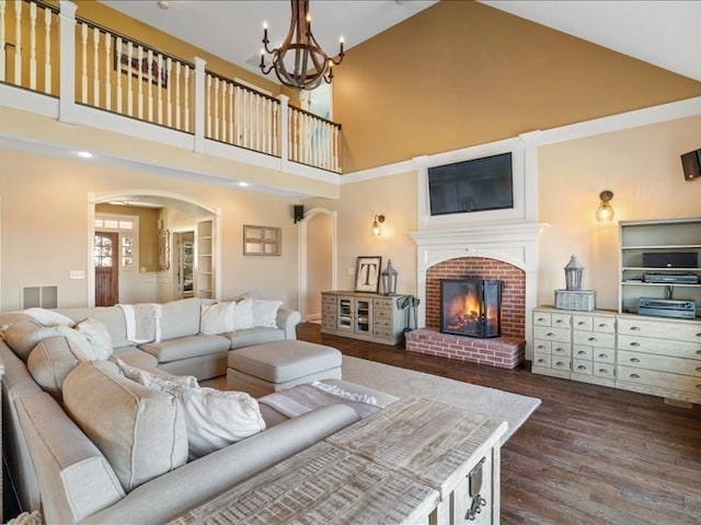 living room featuring a brick fireplace, high vaulted ceiling, and dark hardwood / wood-style flooring