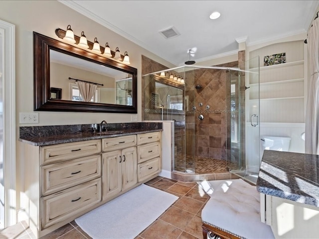 bathroom with vanity, crown molding, a shower with shower door, and tile patterned flooring