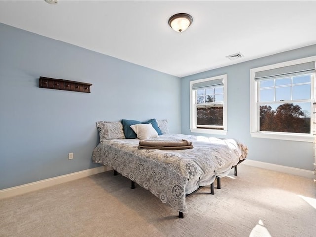 bedroom with light colored carpet