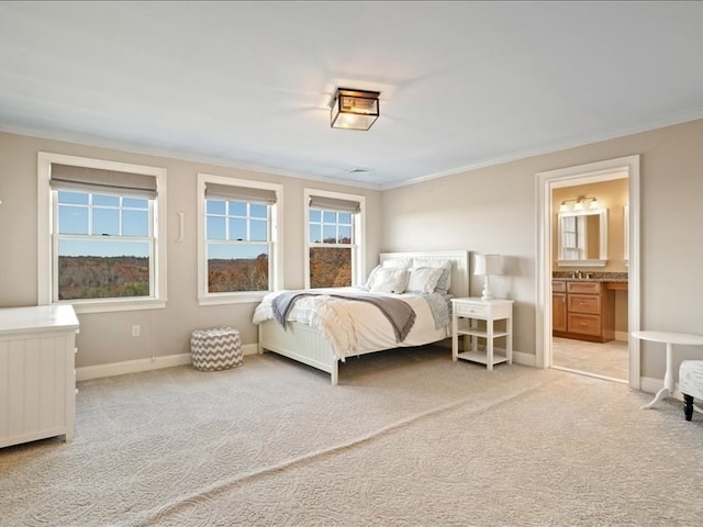 carpeted bedroom featuring ensuite bathroom and ornamental molding