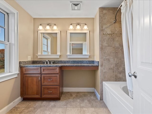 bathroom featuring vanity, tile patterned flooring, and shower / tub combo