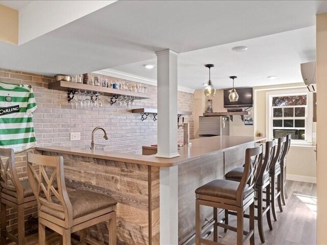 143 Clemence Hill Rd, Southbridge, MA 01550 - indoor wet bar with wood finished floors, pendant lighting, baseboards, a wall mounted air conditioner, and crown molding