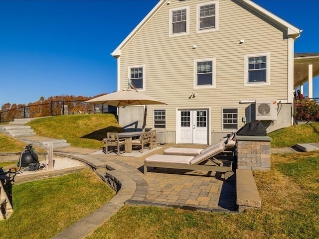 back of house with ac unit, a patio area, and a lawn