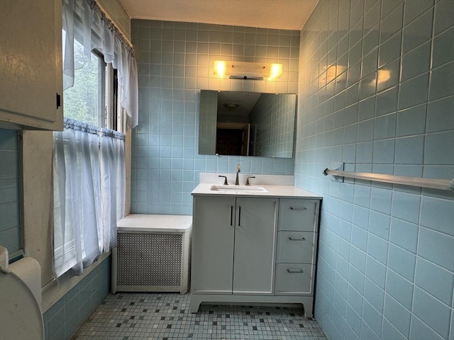 117 Rogers, West Springfield, MA 01089 - bathroom with tile walls, vanity, tile patterned flooring, and radiator heating unit