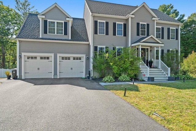 view of front of house with a garage and a front yard